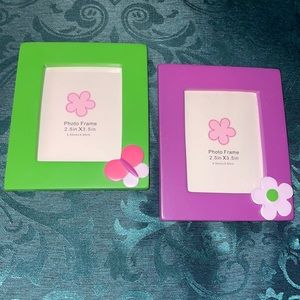 Two, 2.5in X 3.5in frames. One green with butterfly, one purple with flower.